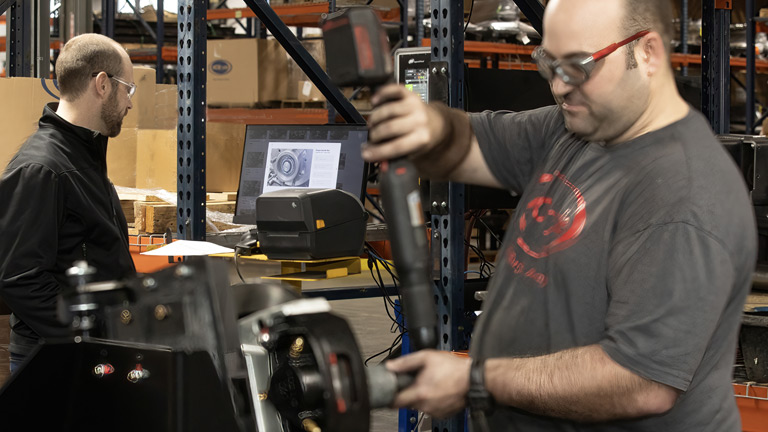 Engineer Jeremy Winfield (right) applies torque for independent suspension assembly while Process Improvement Engineer Greg Whitt (left) examines data in Pico MES.